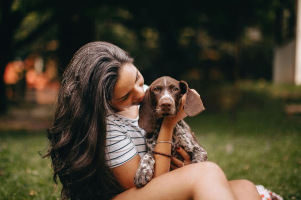 A Woman Holding Her Pointer Dog