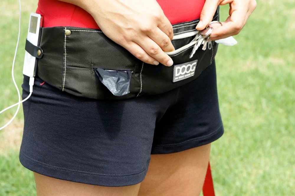 Dog owner wearing Doog walkie belt while walking her dog